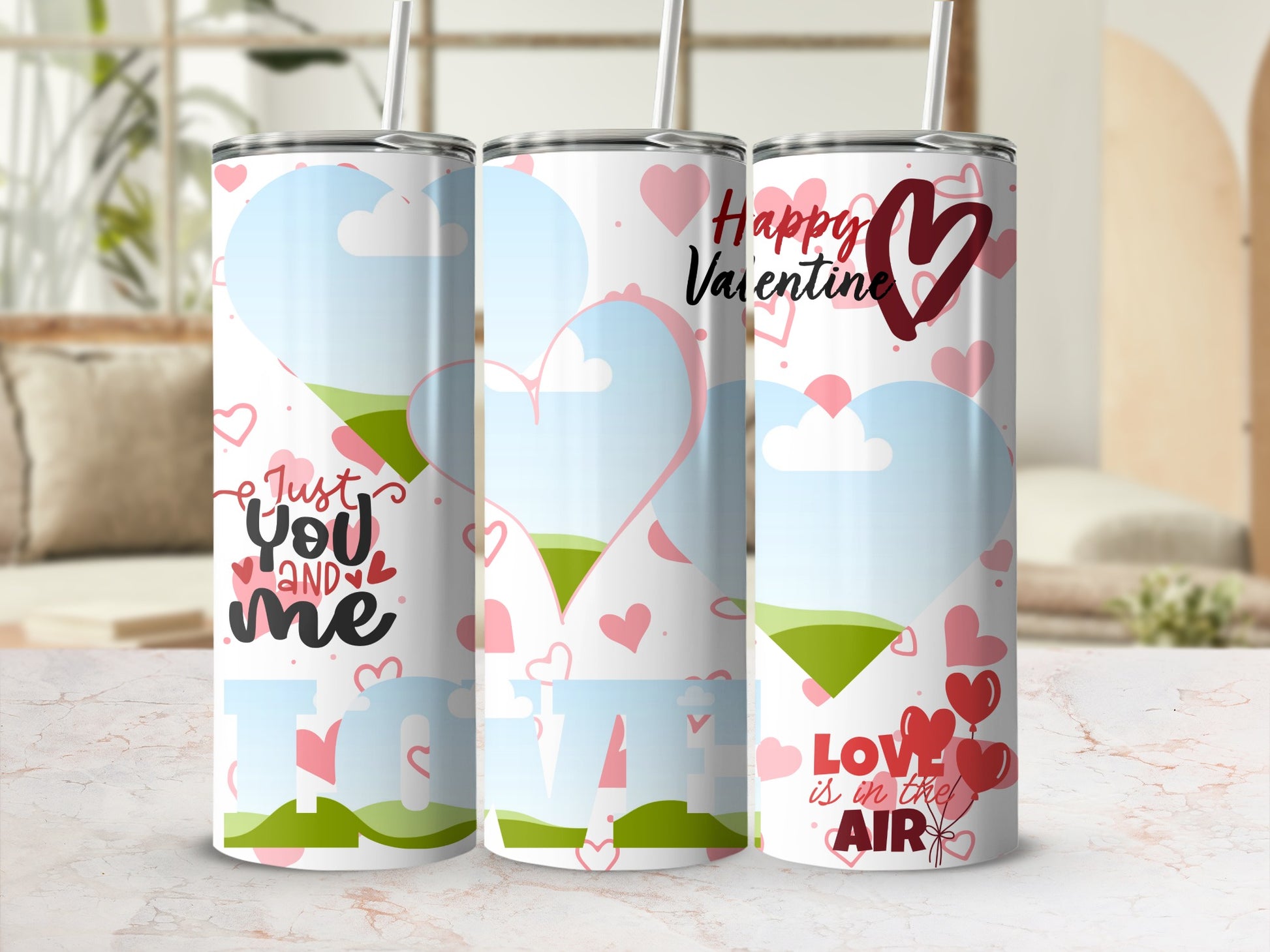 Three tumblers with Valentine's Day designs: "Just You and Me", "Love", and "Love is in the Air".