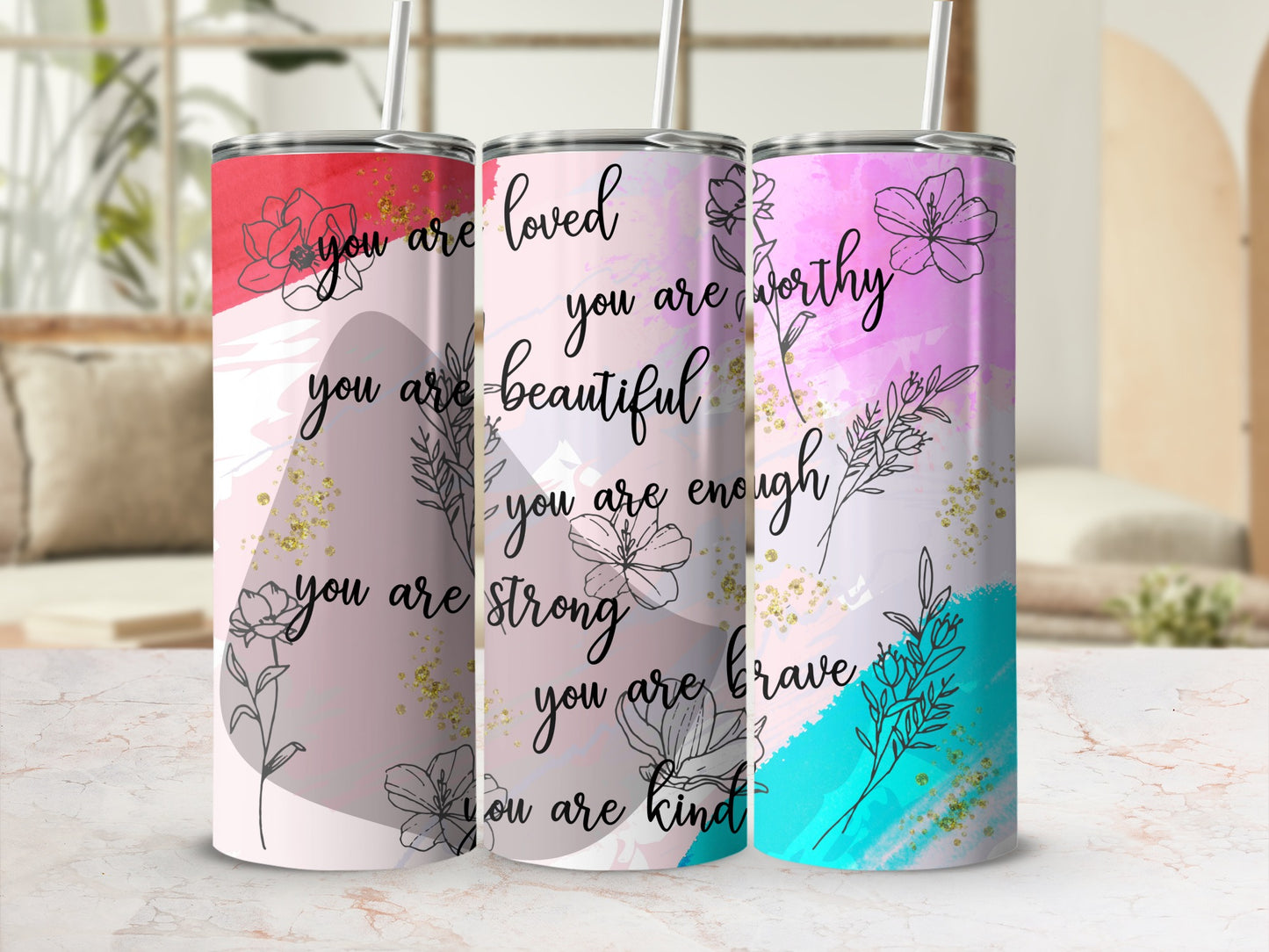 Tumbler with "you are loved" and empowering phrases in floral design.