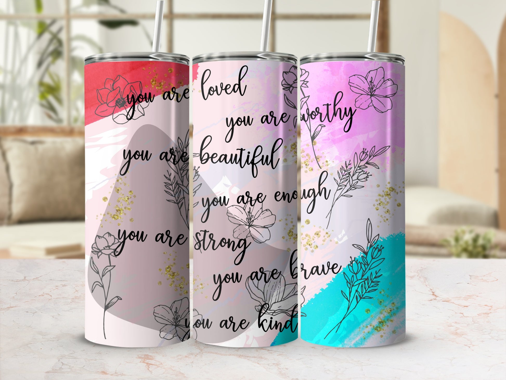 Tumbler with "you are loved" and empowering phrases in floral design.