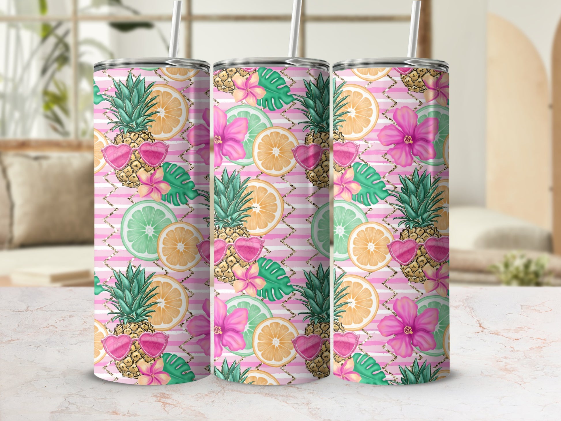 Three tumblers with pineapple, citrus, and floral pattern.