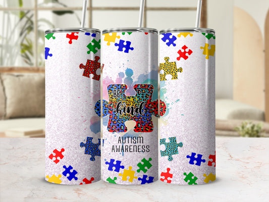 Tumbler with "Be Kind" and puzzle pieces, promoting autism awareness.