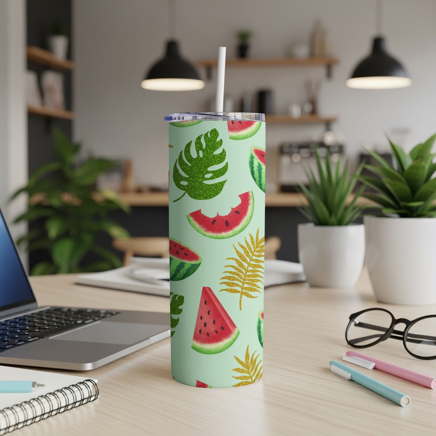 Mint green tumbler with watermelon and glitter leaf pattern, straw inserted.