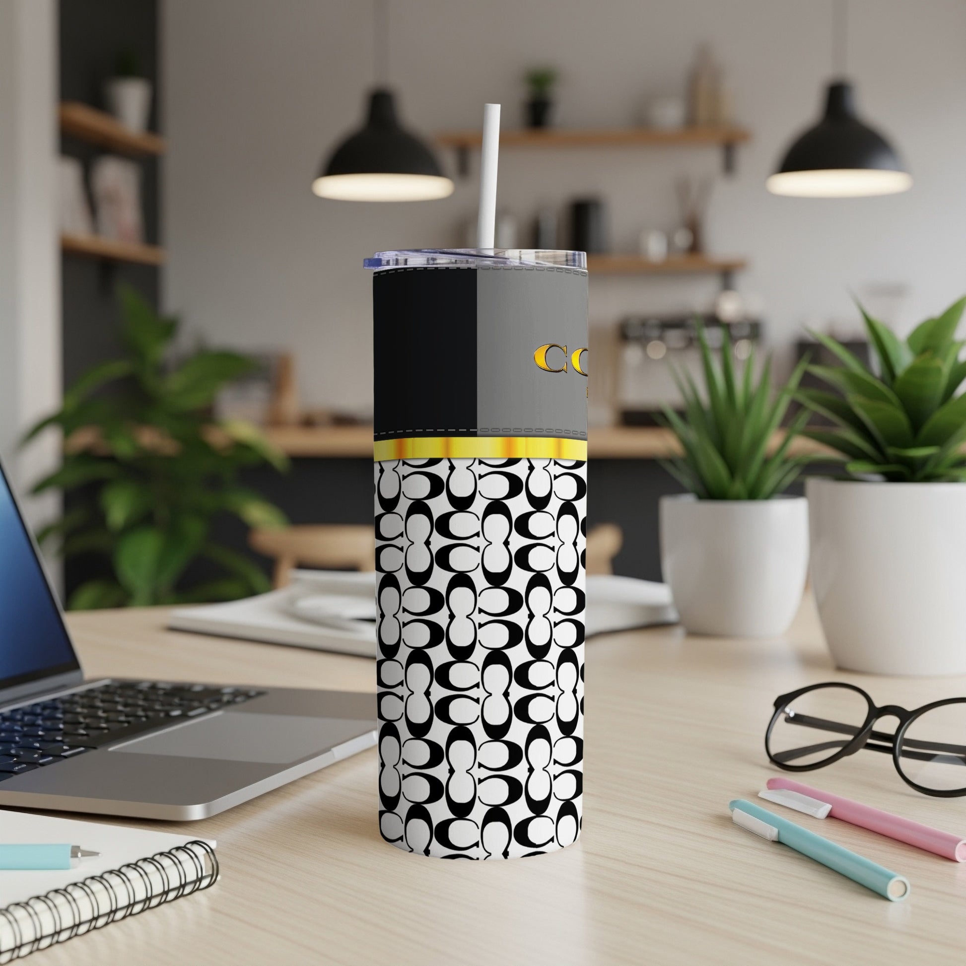 Tall tumbler with black and gray top, yellow band, and patterned base, featuring the Coach logo.