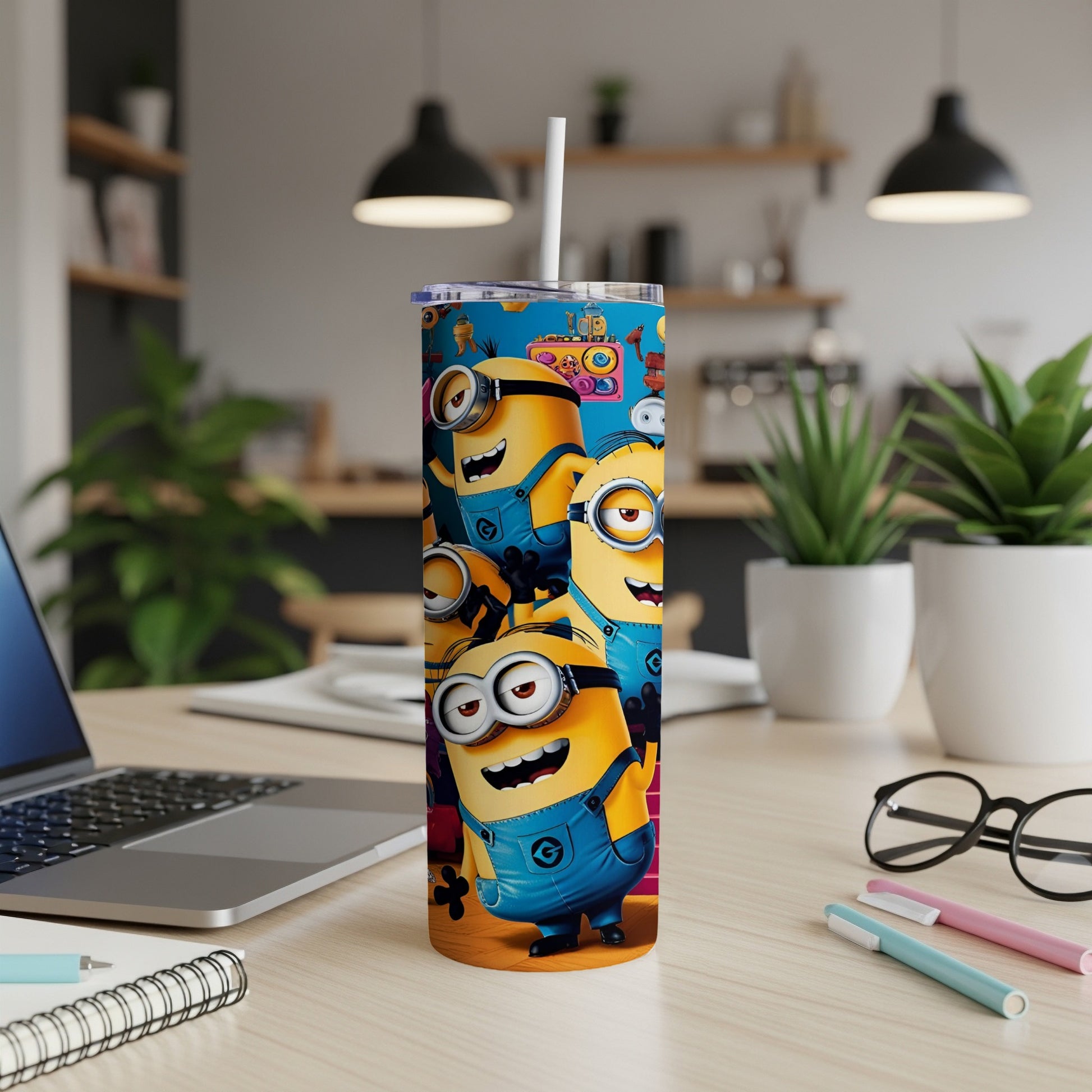 Minions characters on a blue tumbler with a straw, on a desk.