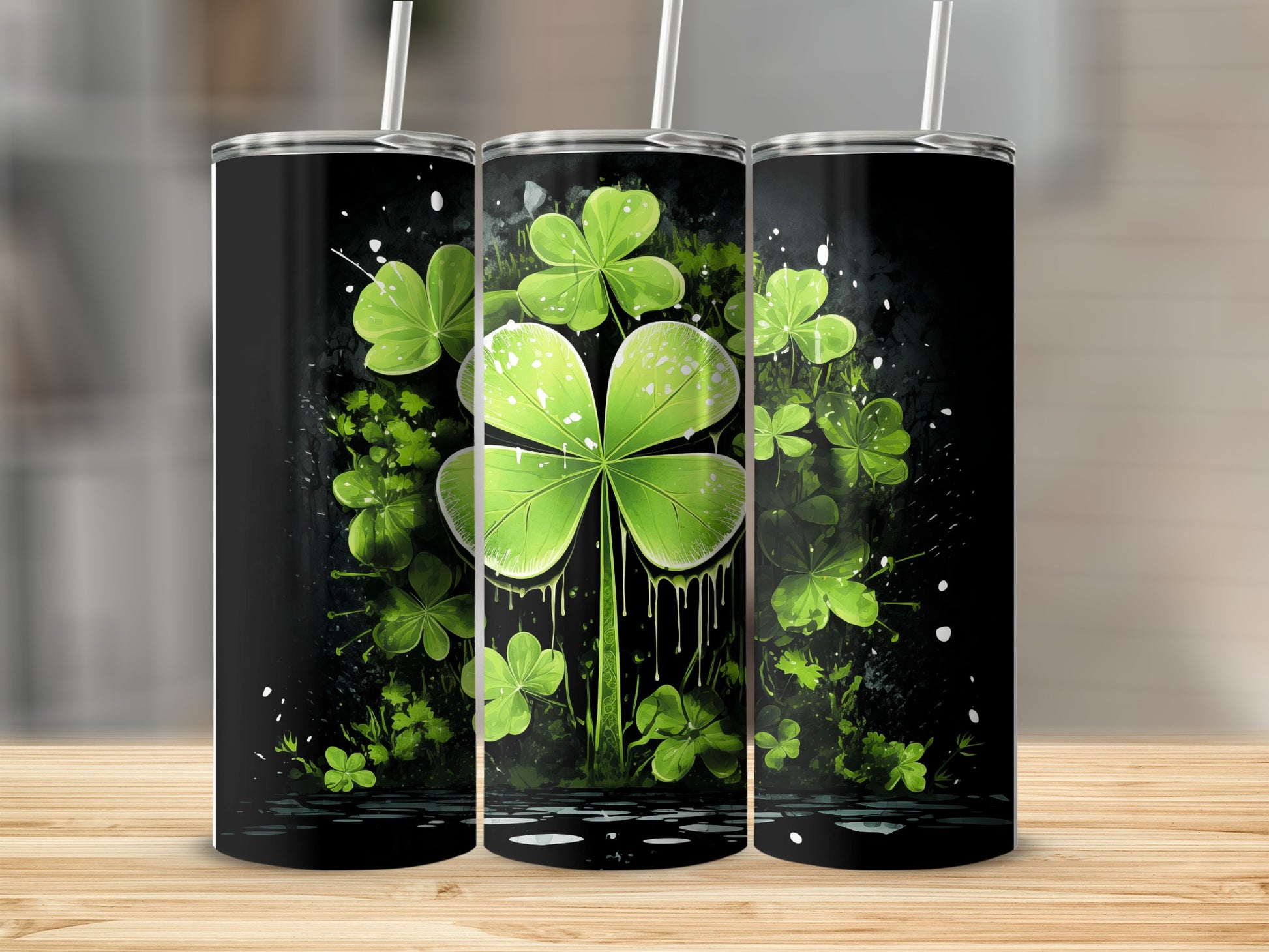Three tumblers with a green shamrock and splatter design.