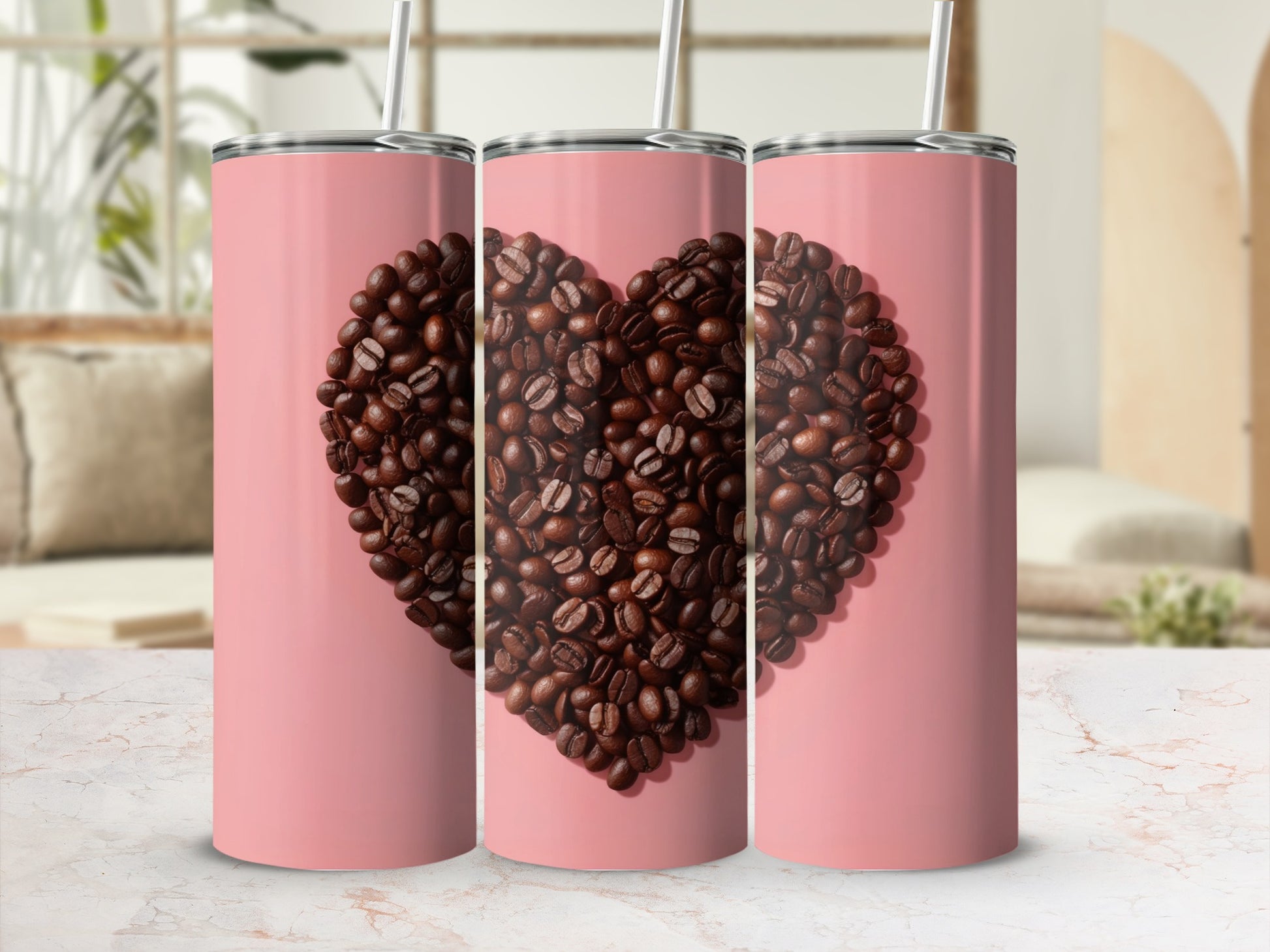 Three pink tumblers with a heart made of coffee beans on the front.