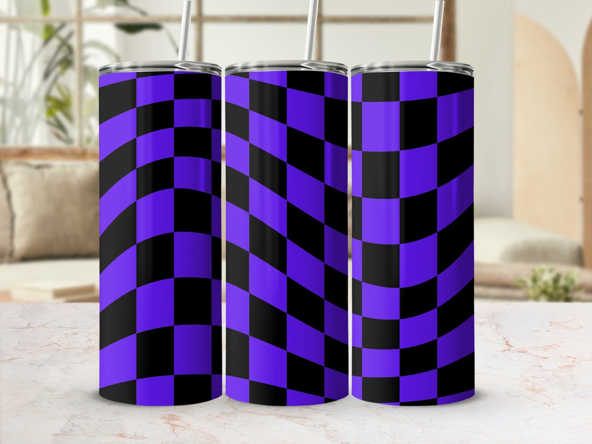 Three purple and black checkered tumblers with straws.