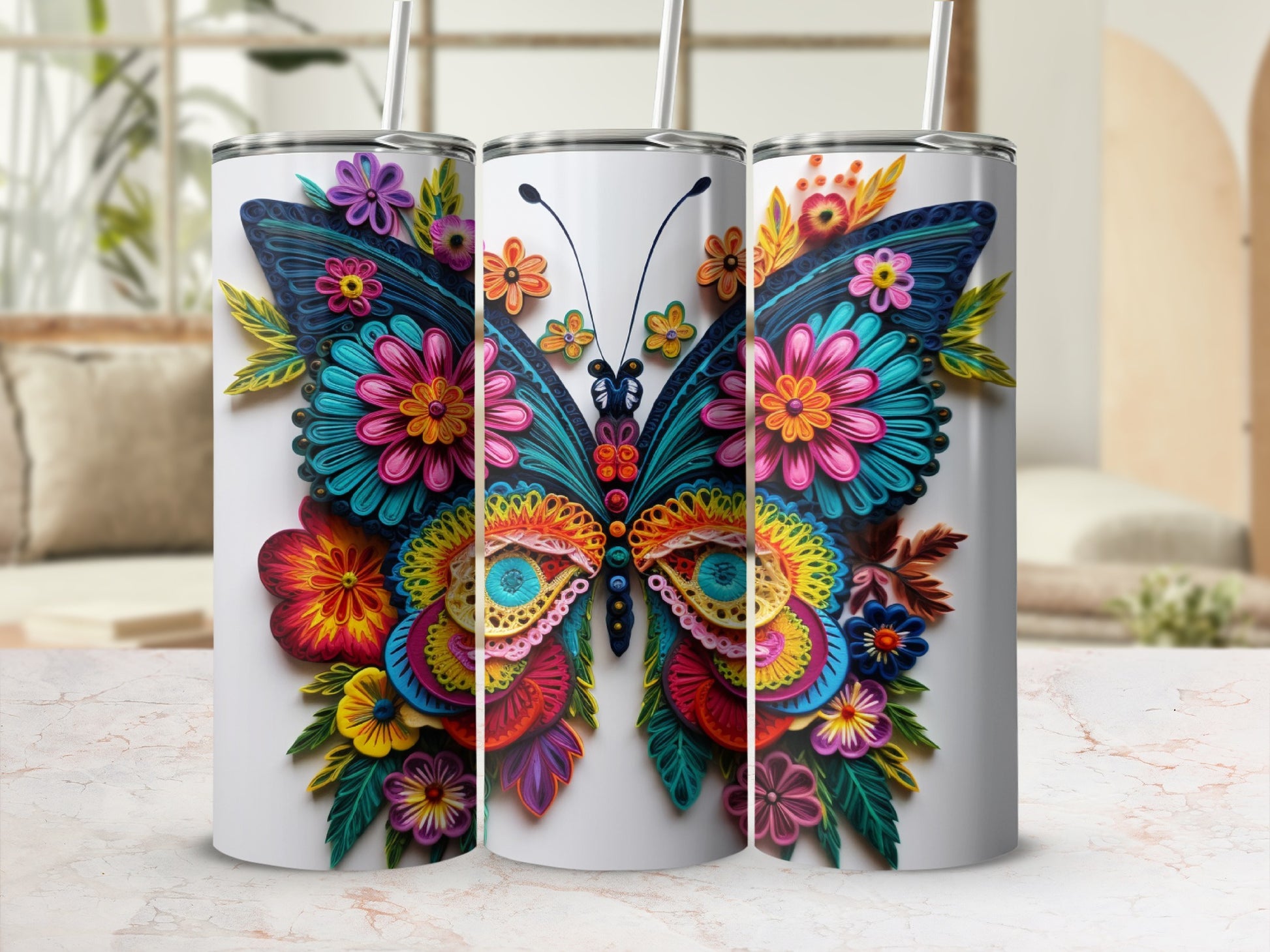 Three tumblers with colorful floral butterfly designs.