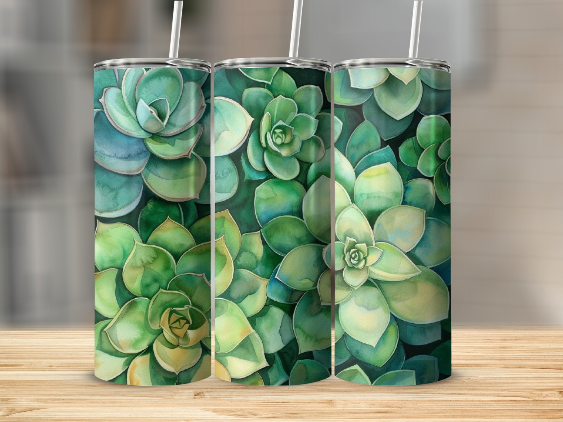 Three tumblers with watercolor succulent designs on a wooden surface.