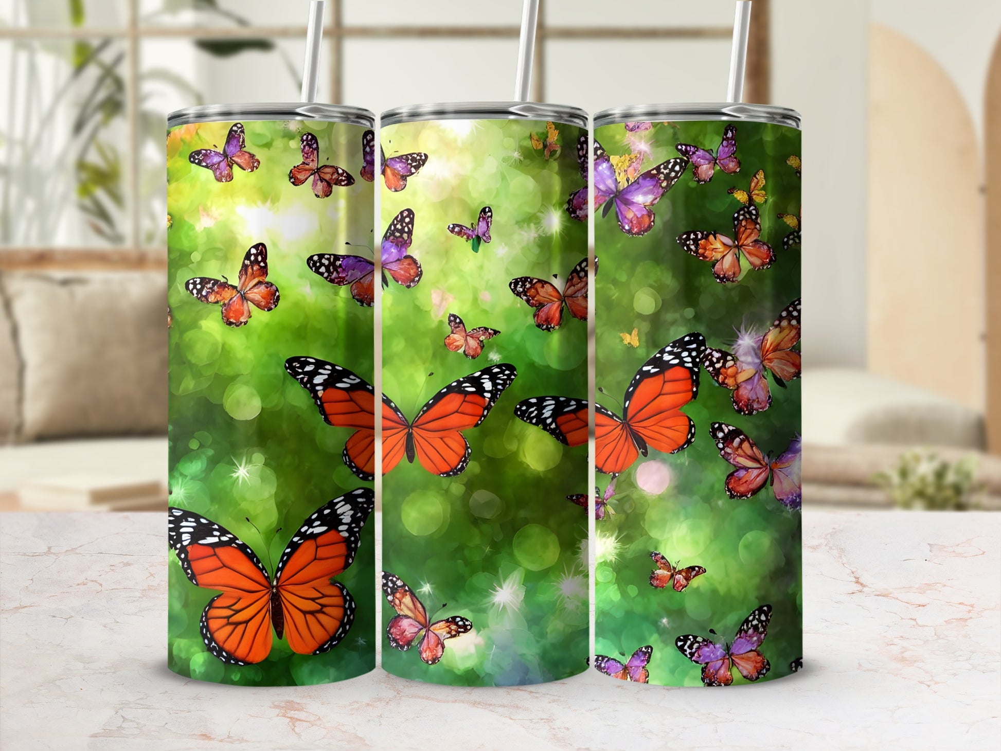 Three tumblers with colorful butterflies and bokeh background.