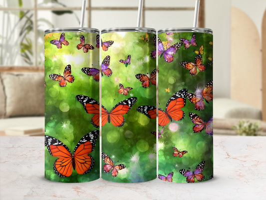 Three tumblers with colorful butterflies and bokeh background.