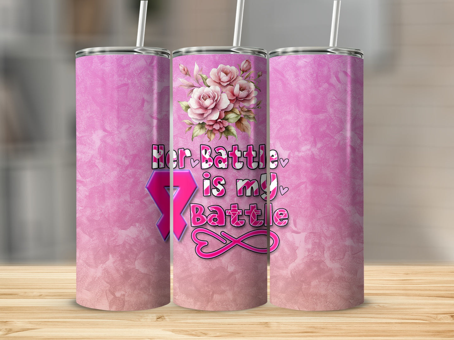 Pink tumbler with floral design and "Her Battle Is My Battle" text.