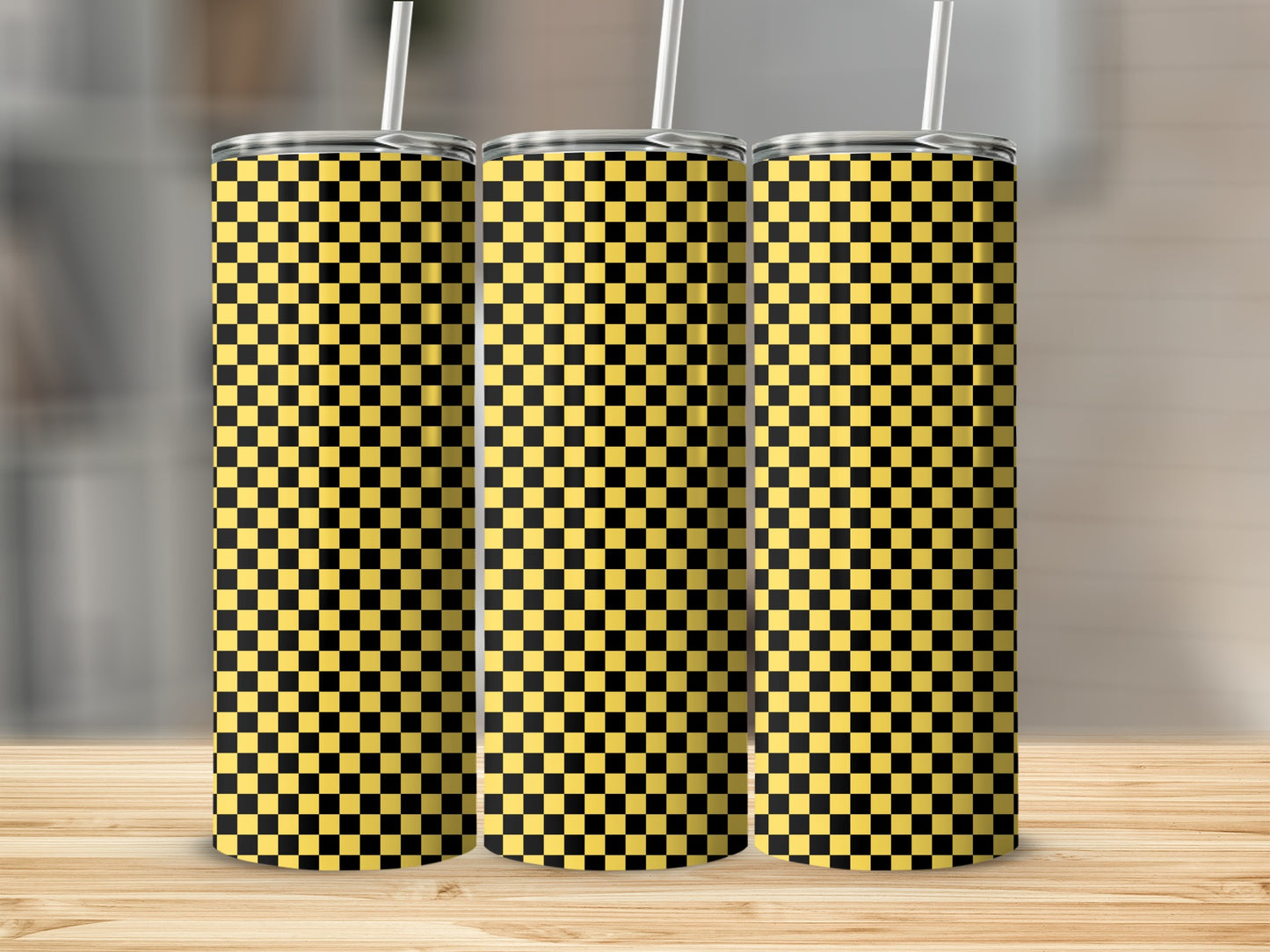 Three tumblers with a black and yellow checkerboard pattern on a wooden surface.