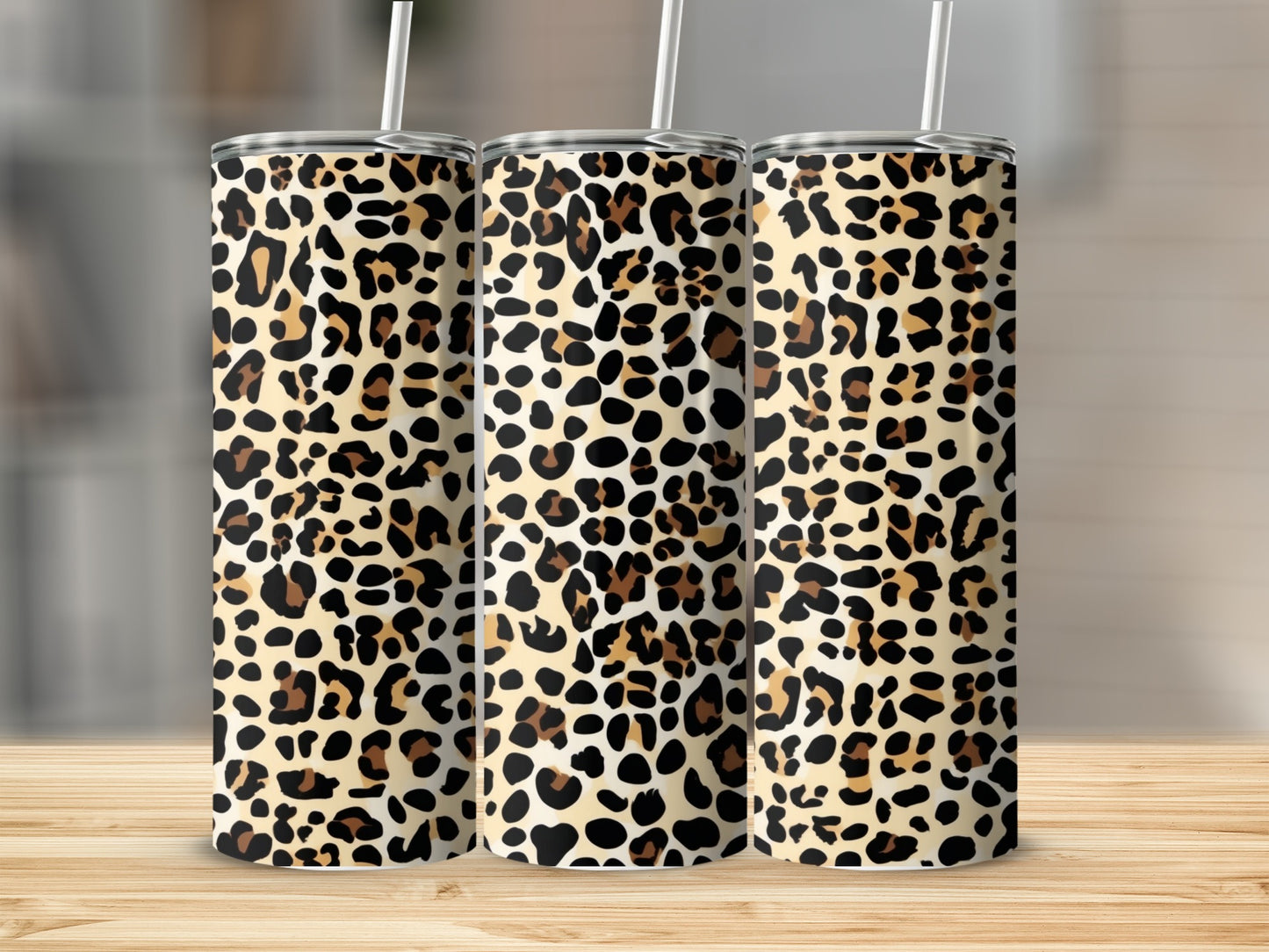 Three tumblers with leopard print and white straws.