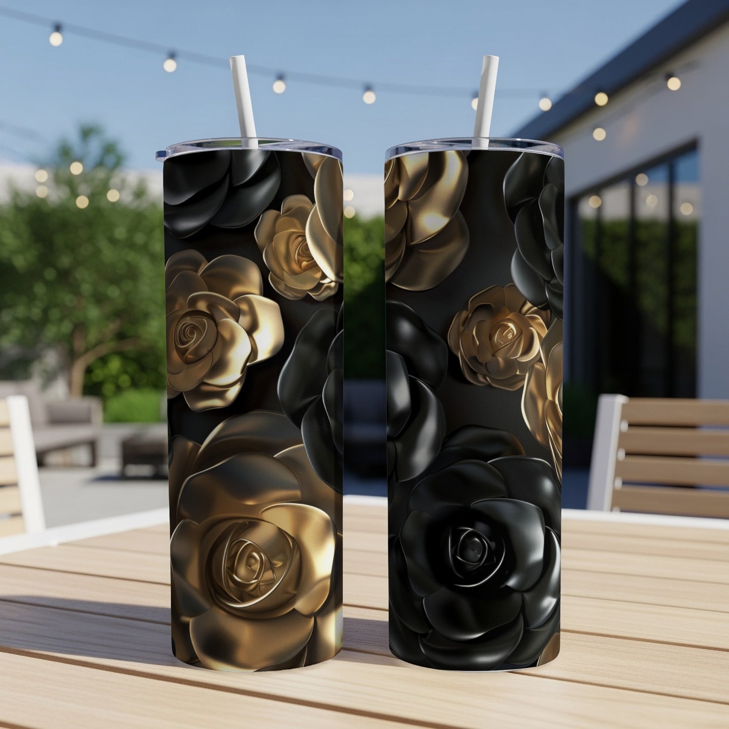 Two tall tumblers with black and gold floral designs sit on a wooden table.