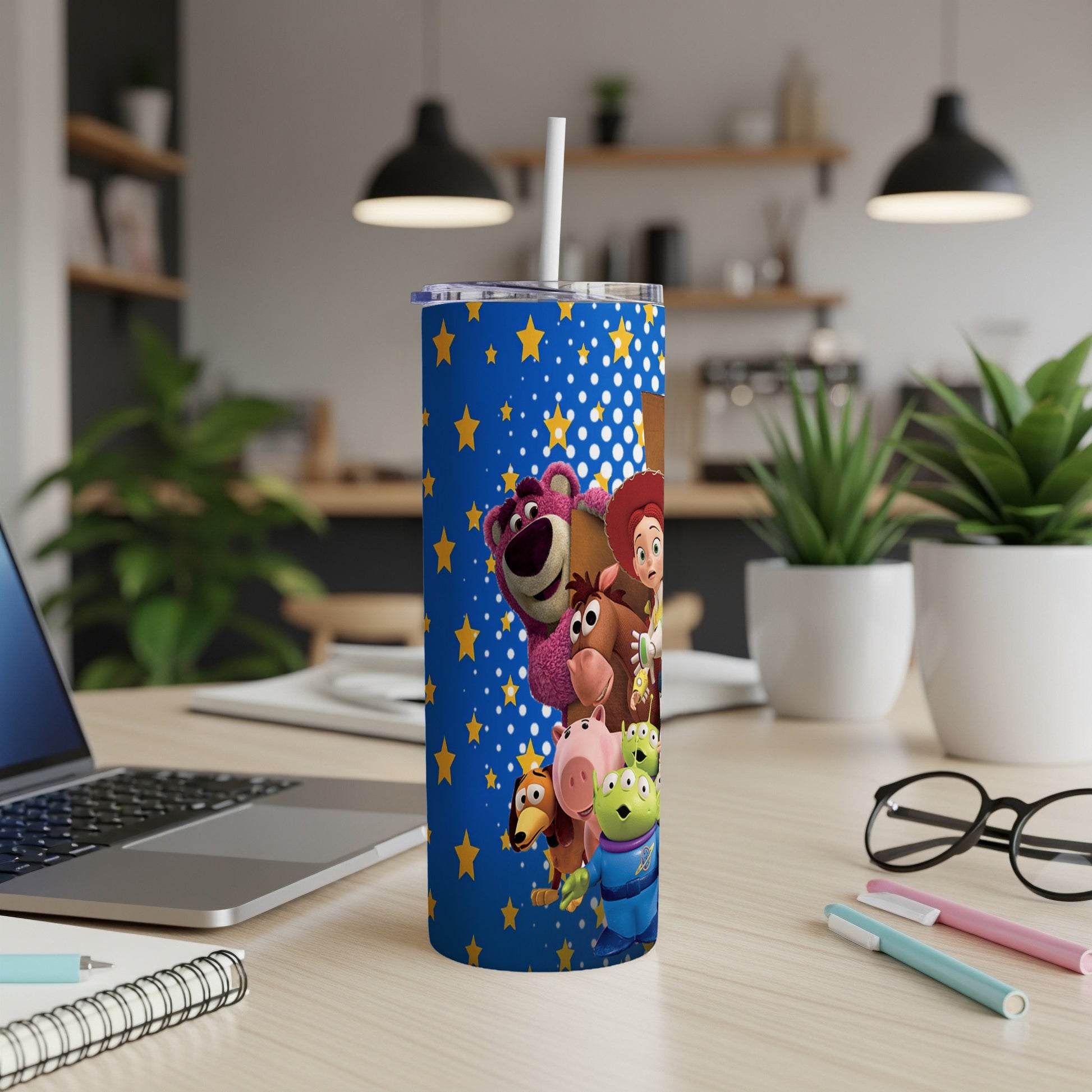 Blue tumbler with Toy Story characters and white polka dots.