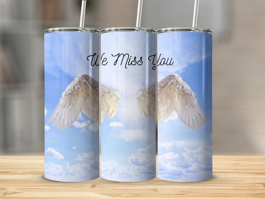 Angel wings with "We Miss You" text on a bright sky background.