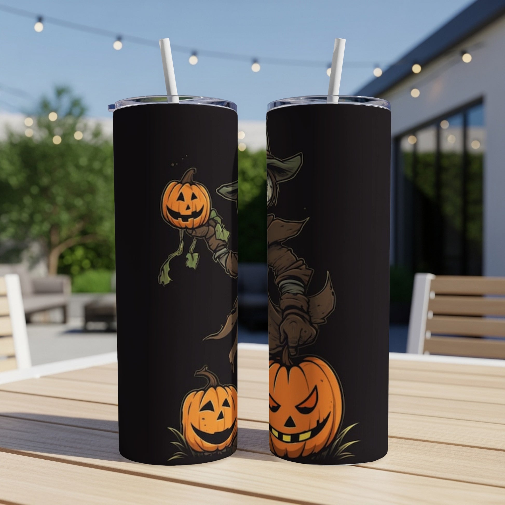 Two black tumblers with spooky scarecrow and pumpkin Halloween illustrations.