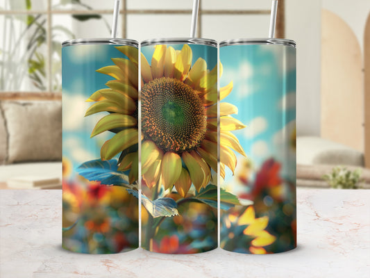 Sunflower design on three tumblers, blurred background with bright light.