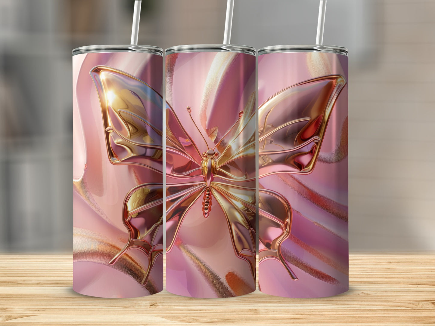 Three tumblers with gold butterfly designs on pink swirled background.