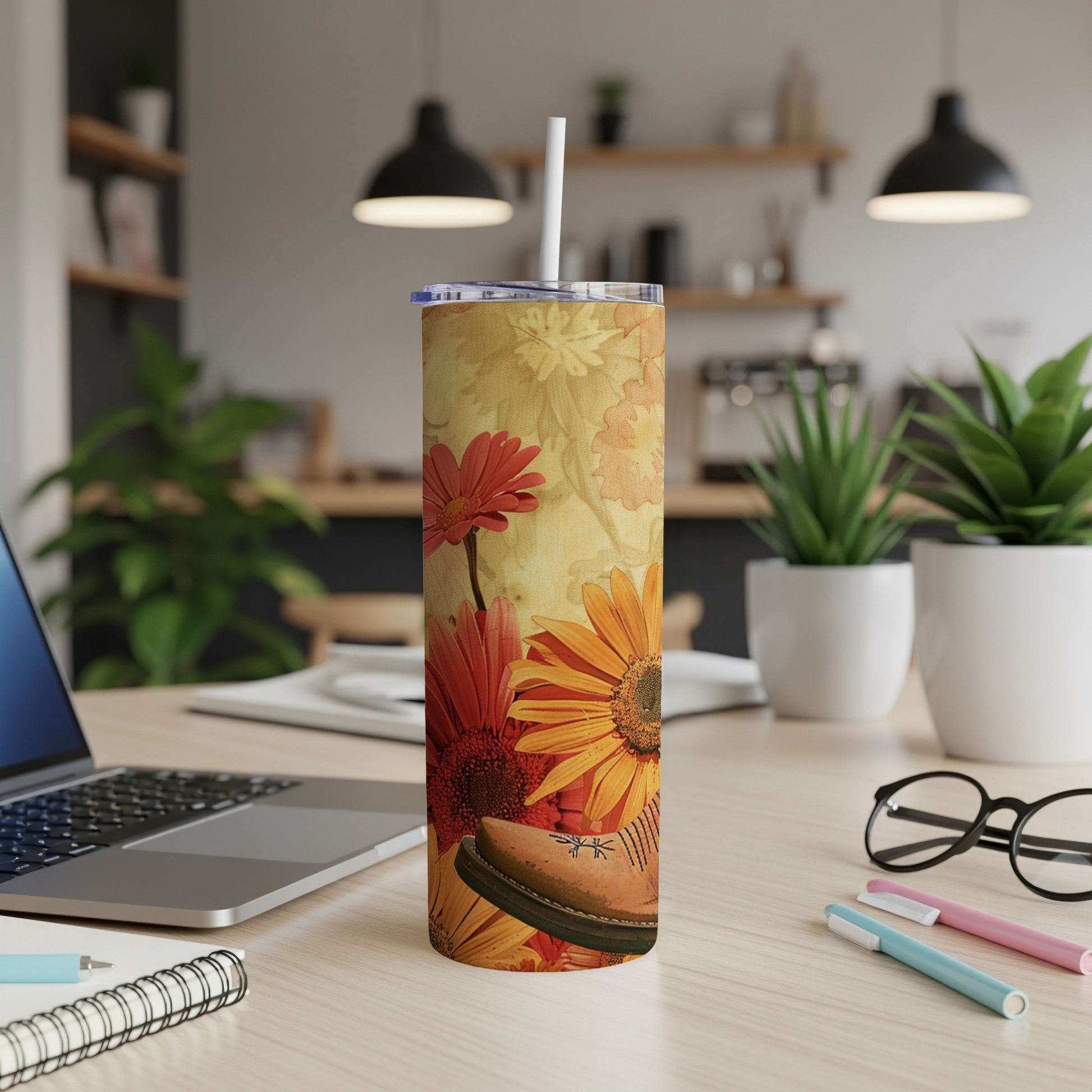 Floral tumbler with a brown shoe design on a desk.