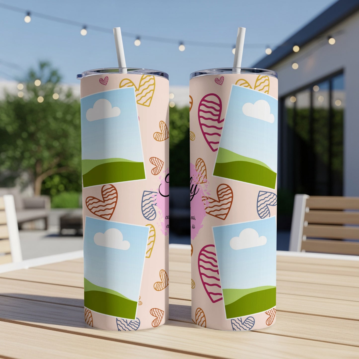Two tumblers with a pink background, hearts, and photo frames on a wooden table.