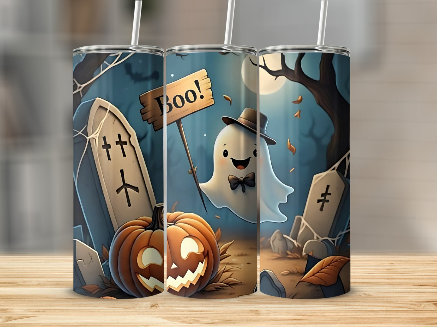 Three tumblers with a Halloween theme, featuring a ghost, pumpkin, and gravestones.