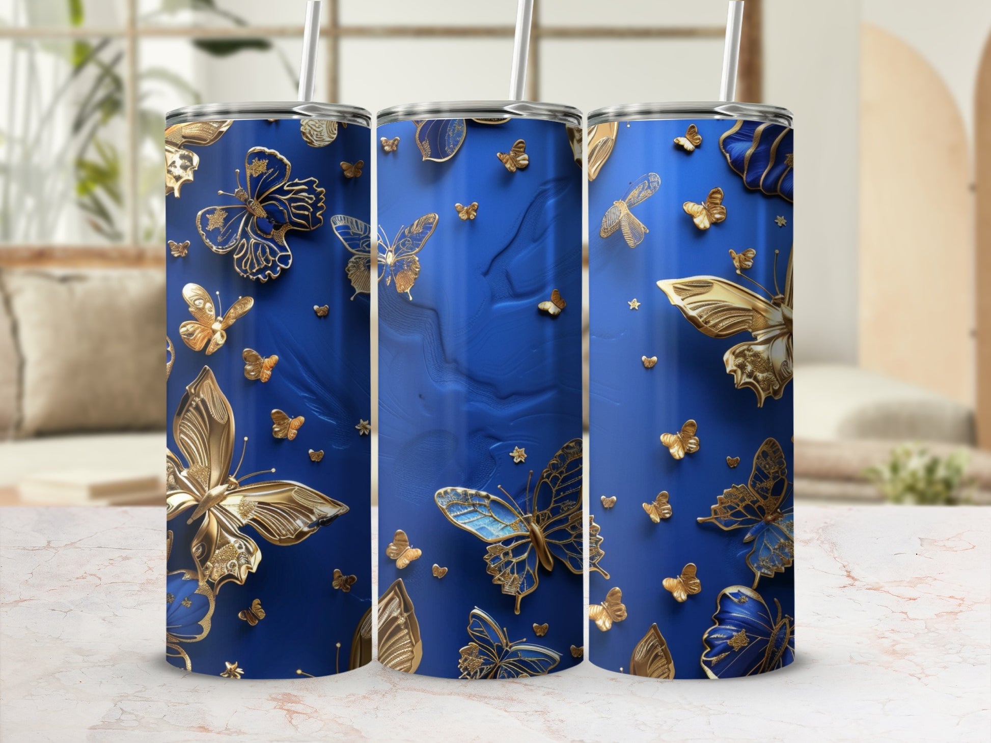 Blue tumbler with gold butterflies and marbled base.