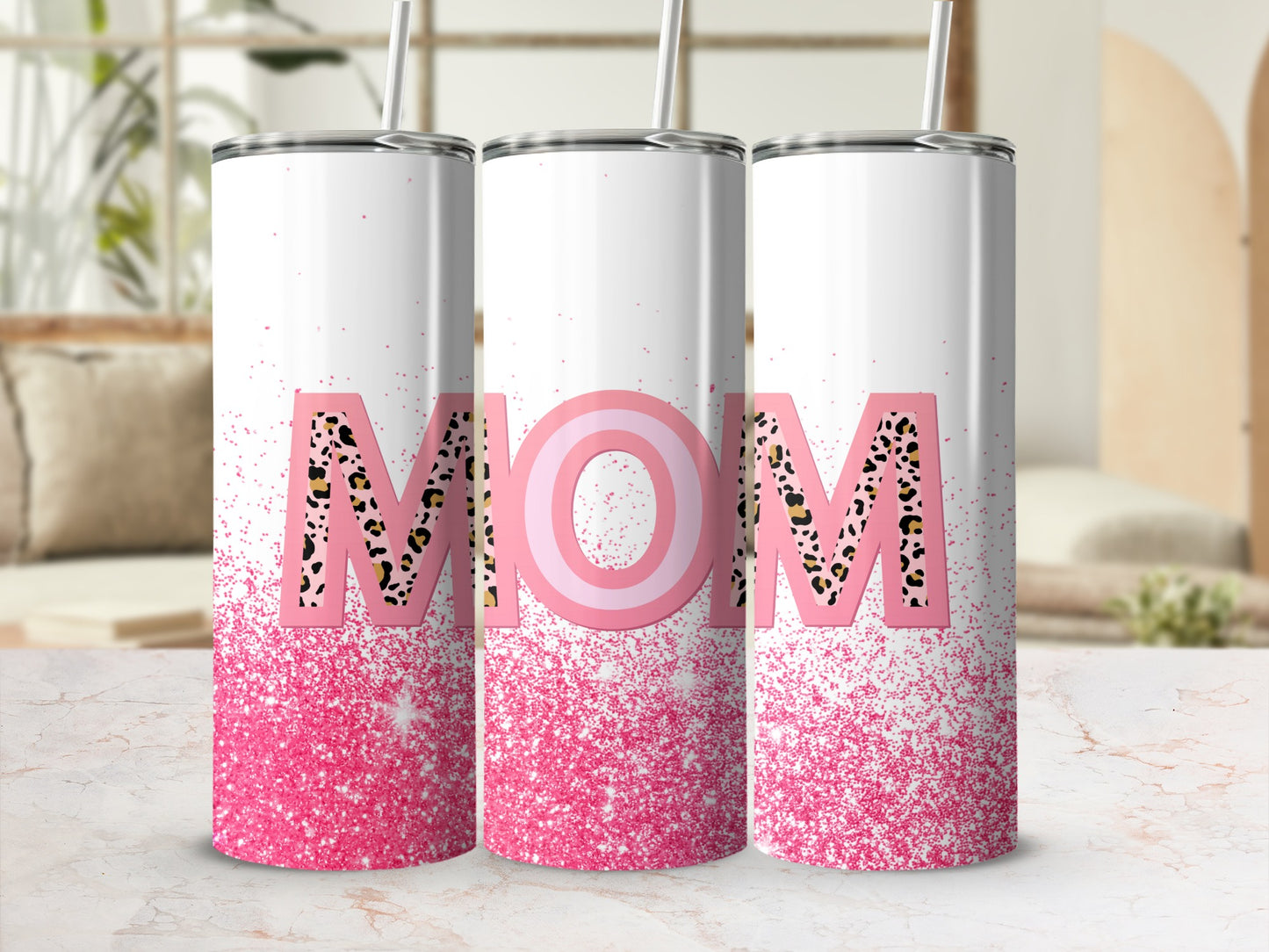 White tumbler with "MOM" in leopard print and pink glitter.