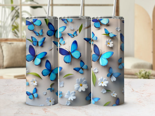 Three skinny tumblers with blue butterflies and white flowers.