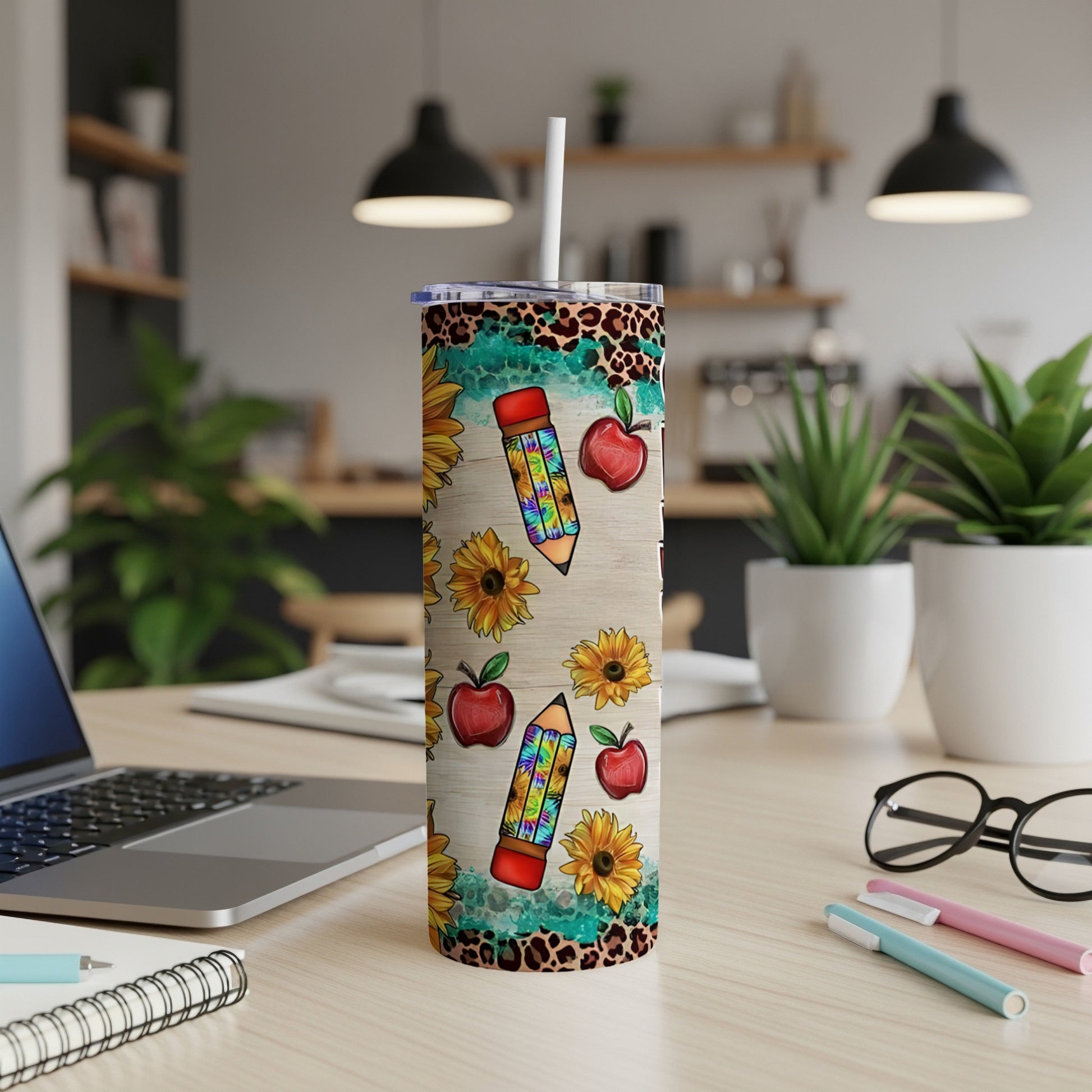 Sunflower and apple pencil design on a white tumbler with a leopard print border.