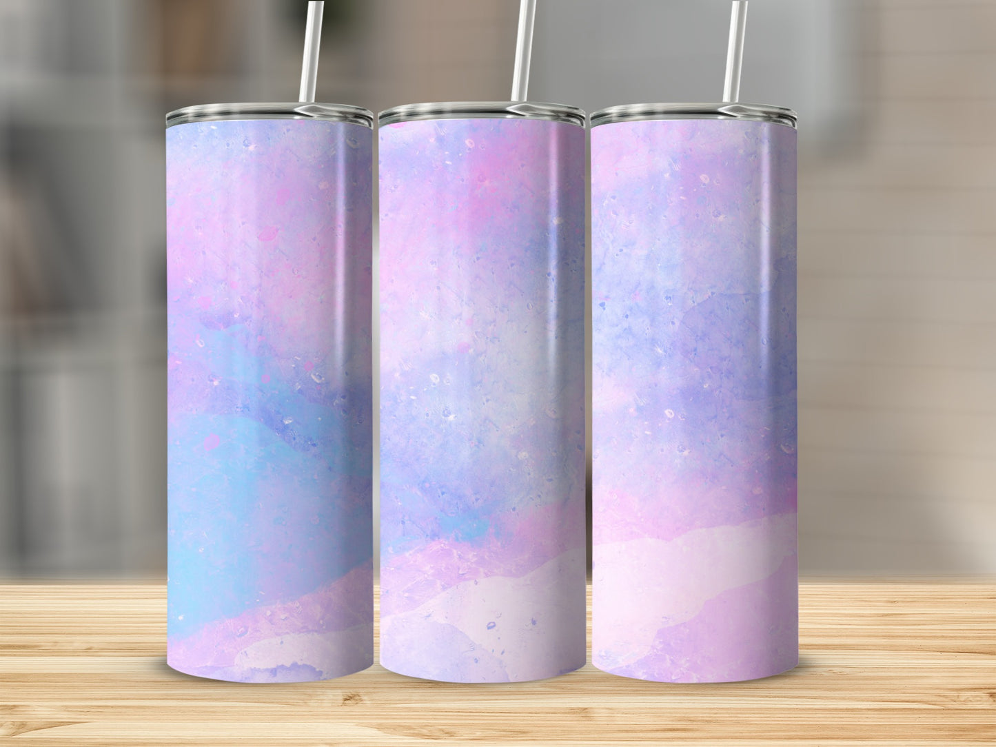 Three tumblers with pastel pink, blue, and purple watercolor designs.