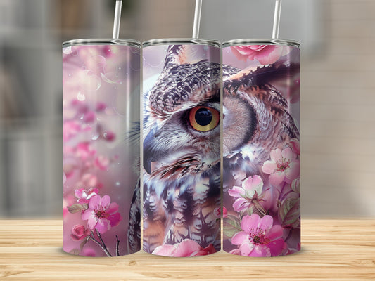 Close-up of a detailed owl face with pink cherry blossoms and bokeh effects.