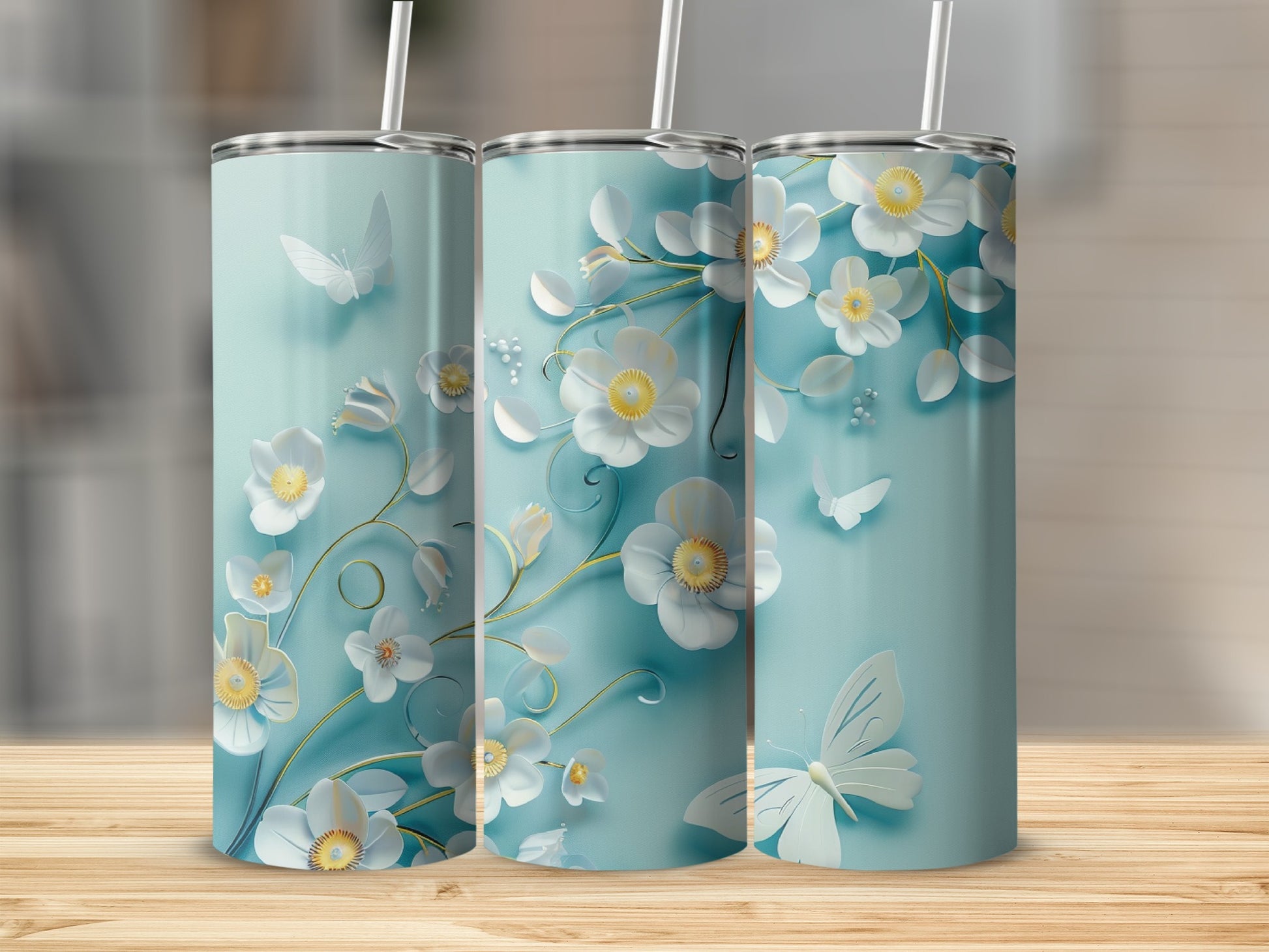 Three tumblers with a light blue floral and butterfly design.