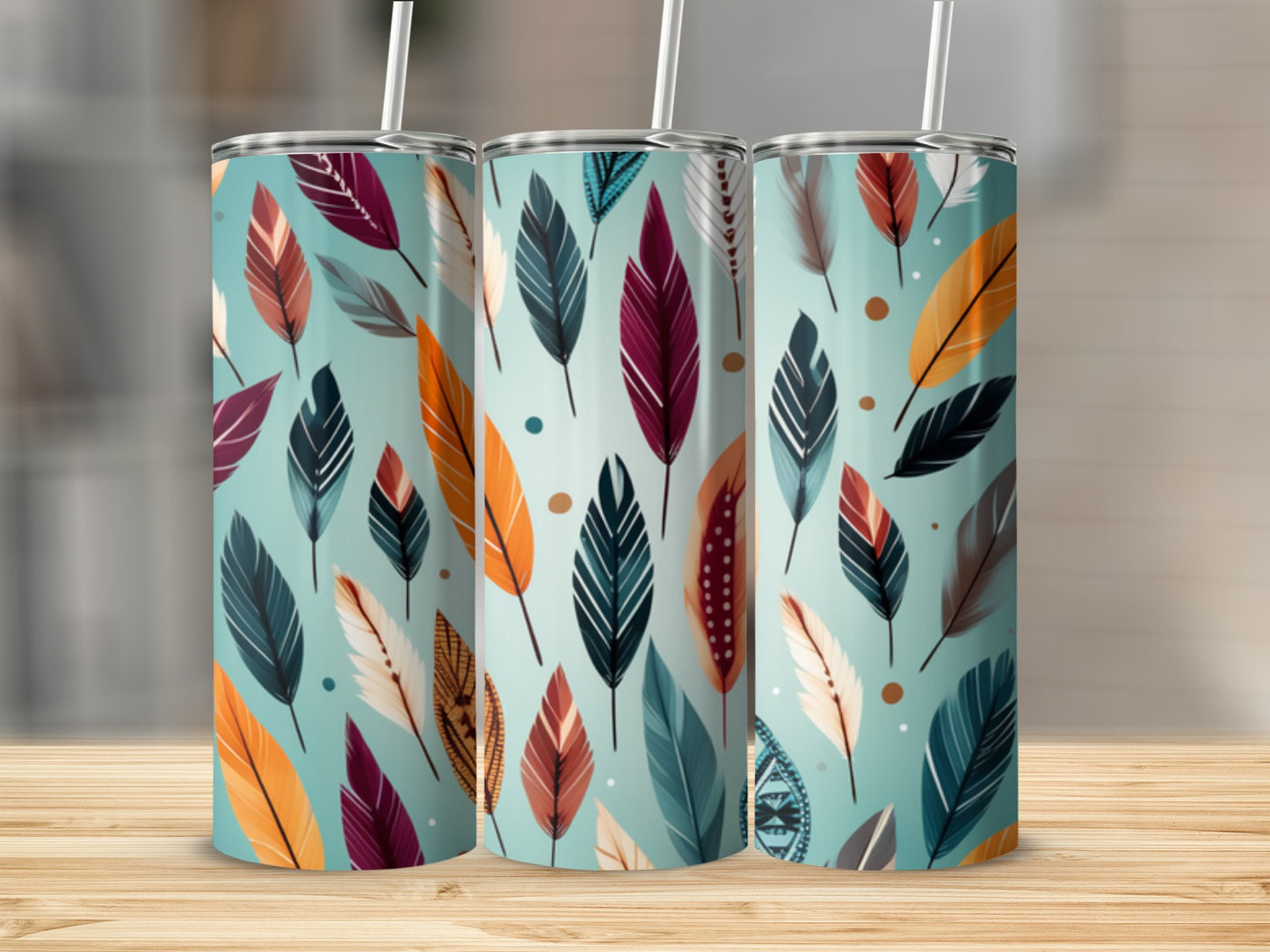 Three tumblers with a teal background and a pattern of colorful feathers.