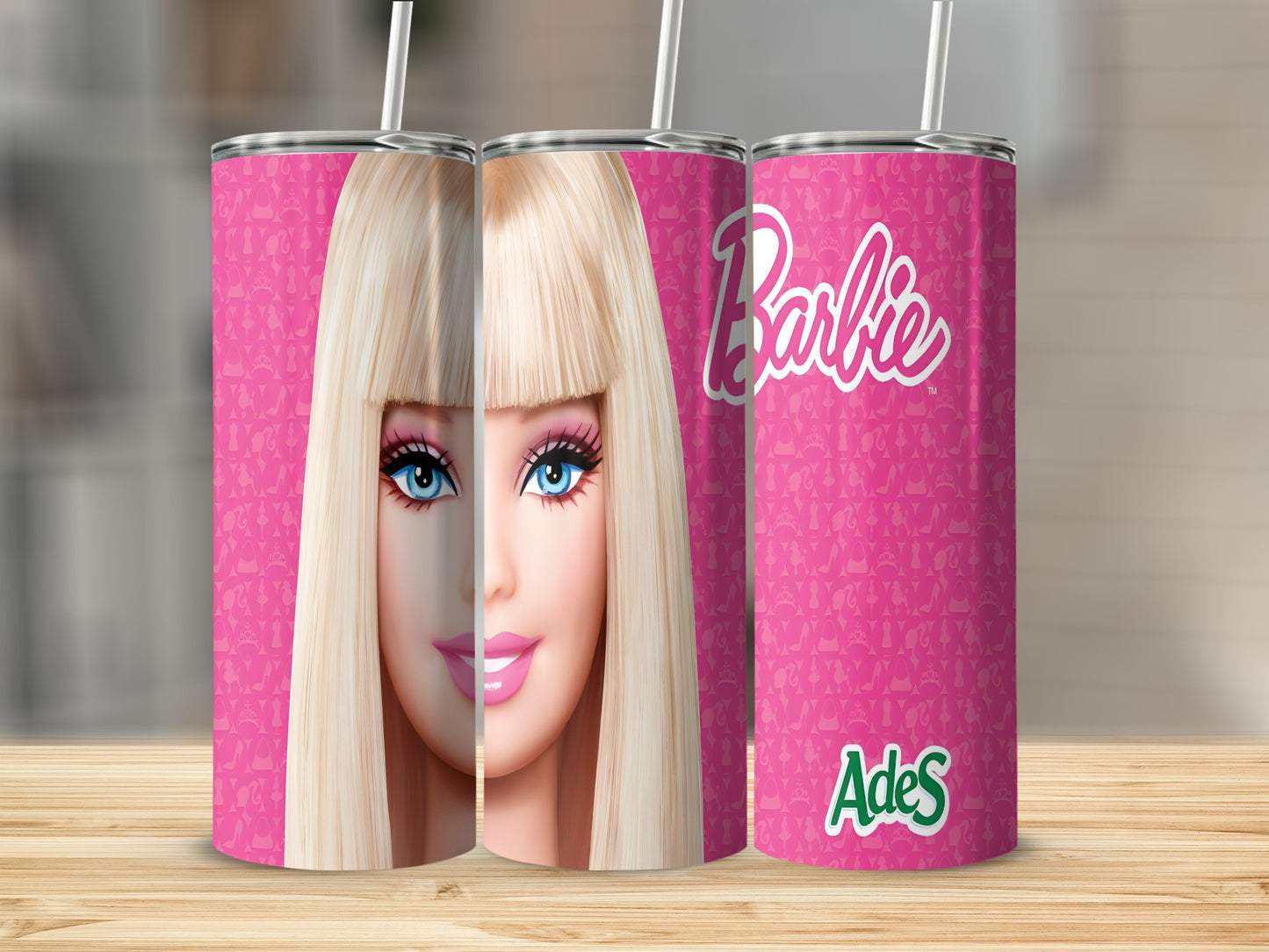 Barbie logo and face on a pink patterned tumbler with straw.