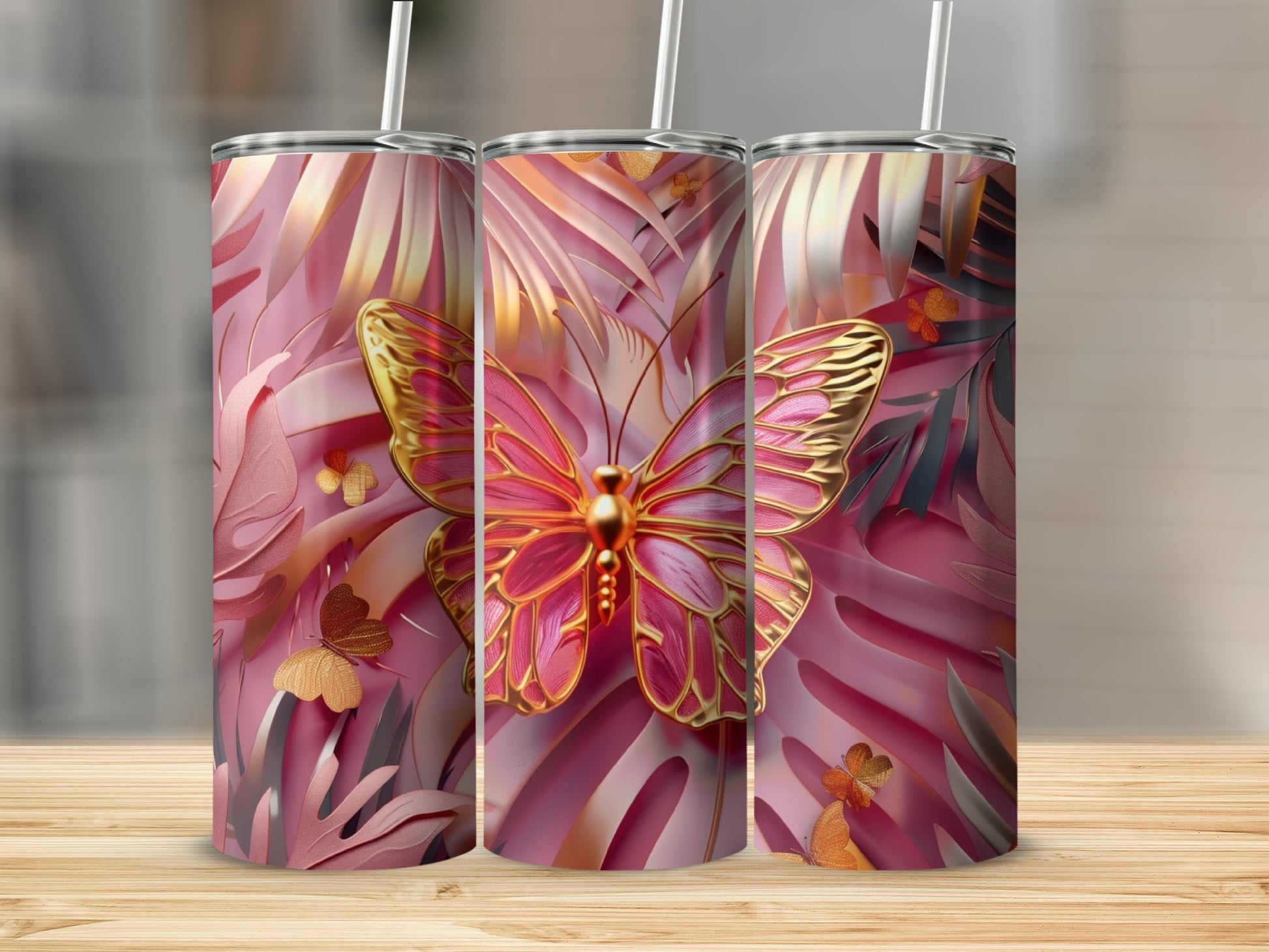 Pink butterfly and palm leaf pattern on three tumblers with straws.