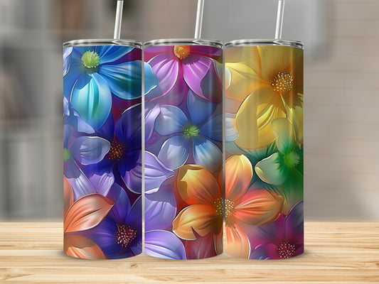 Three colorful tumblers with floral patterns on a wooden surface.