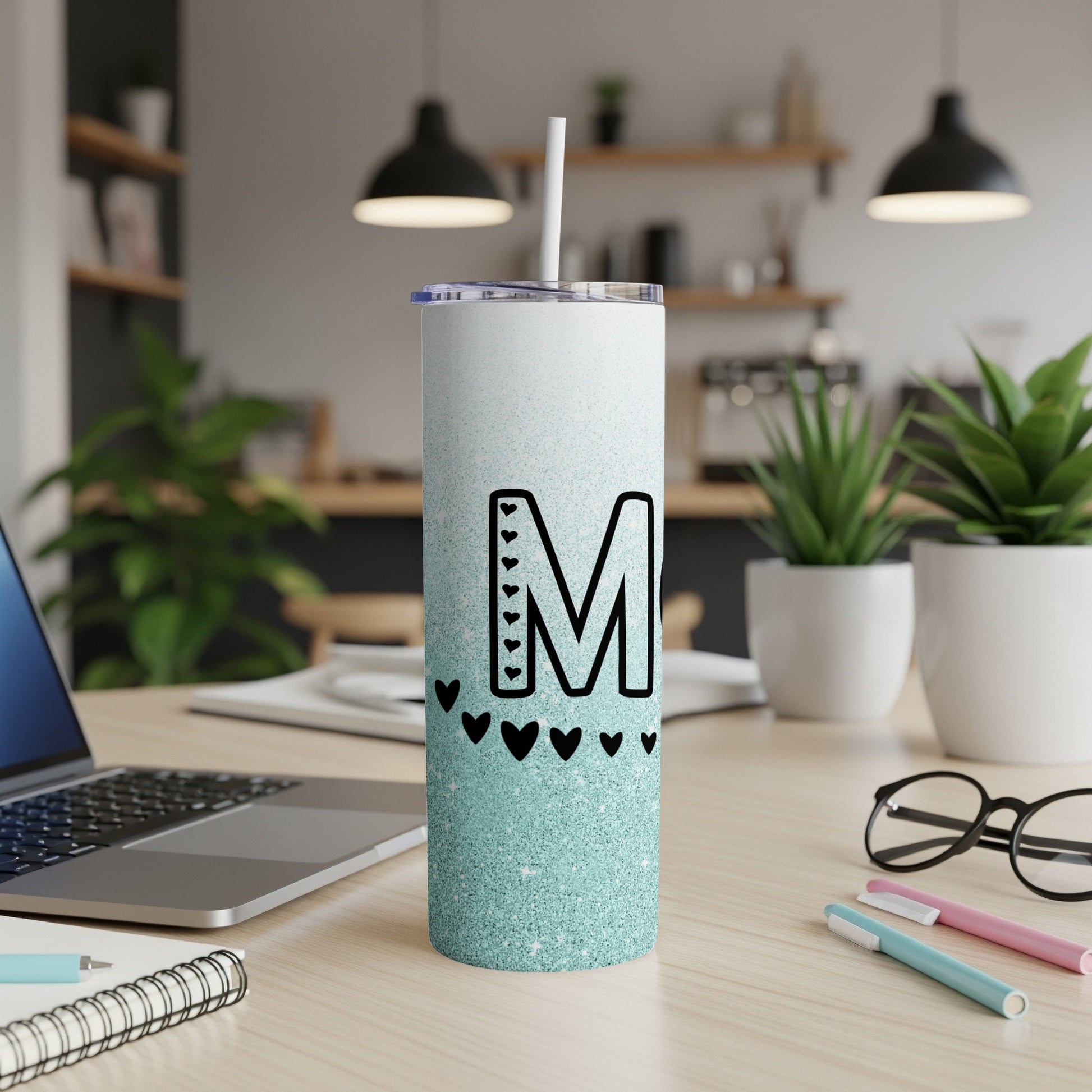 Glittery mint tumbler with letter M and heart accents.