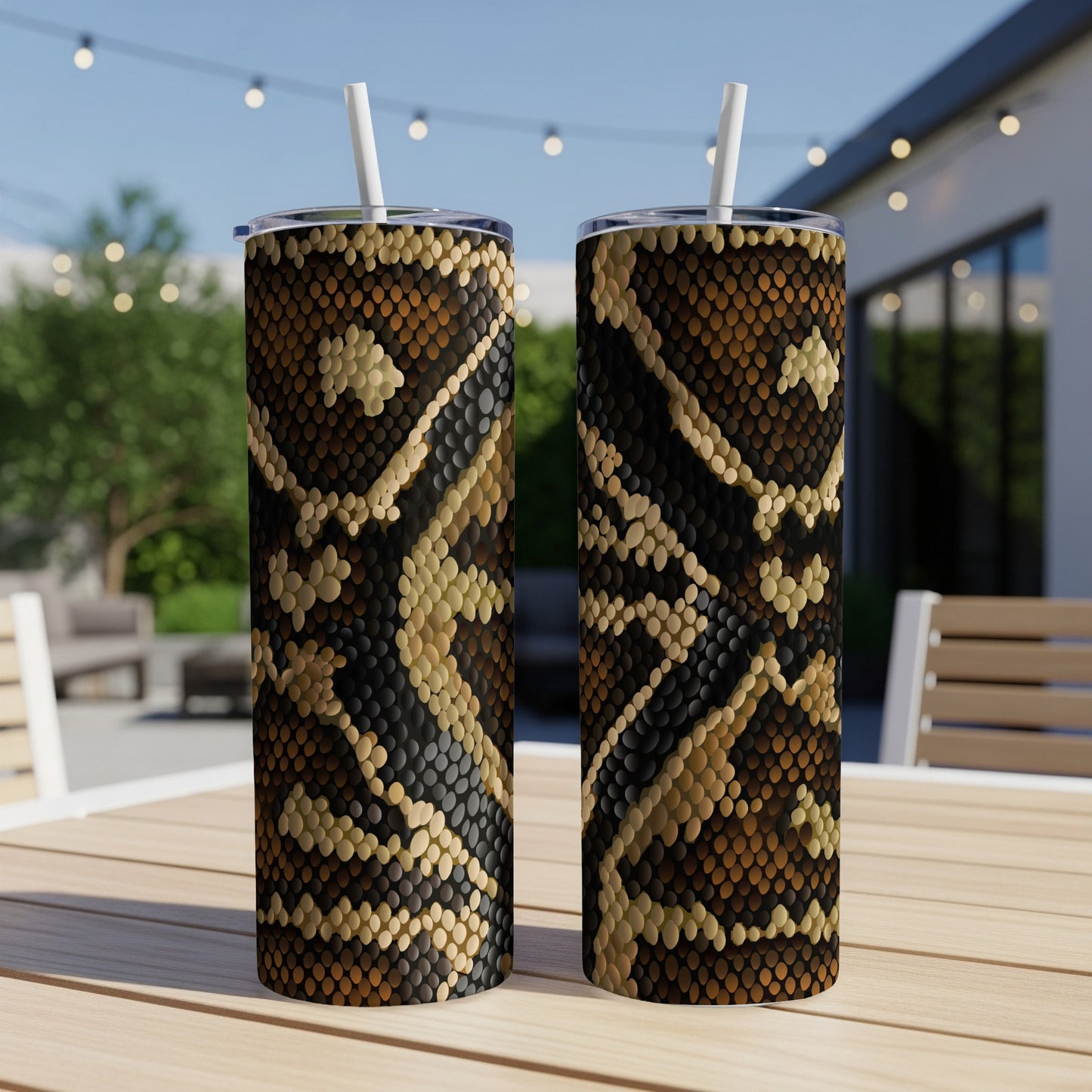 Two tumblers with a brown and black snake skin pattern sit on a wooden table.