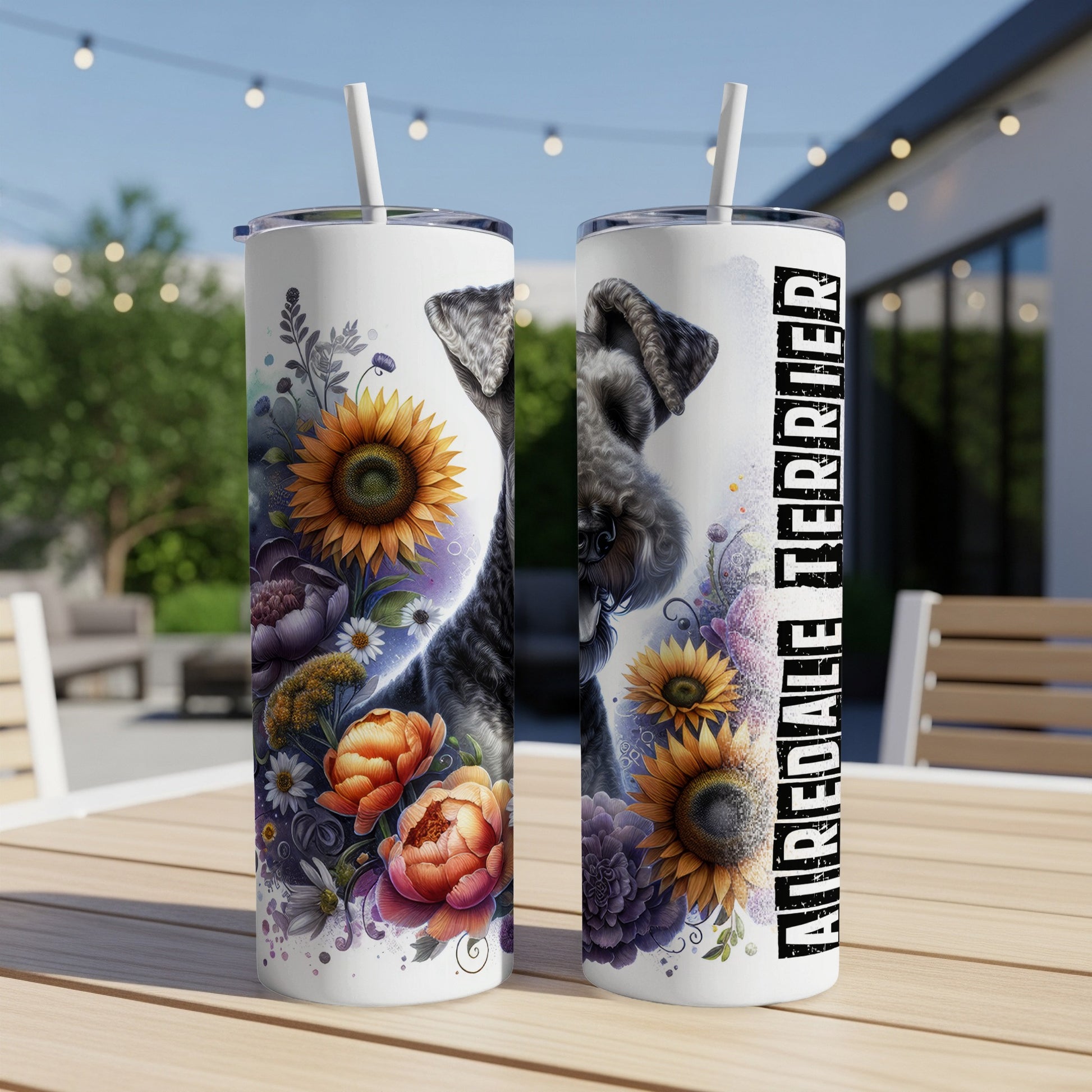 Two Airedale Terrier tumblers with floral and sunflower designs on a table.
