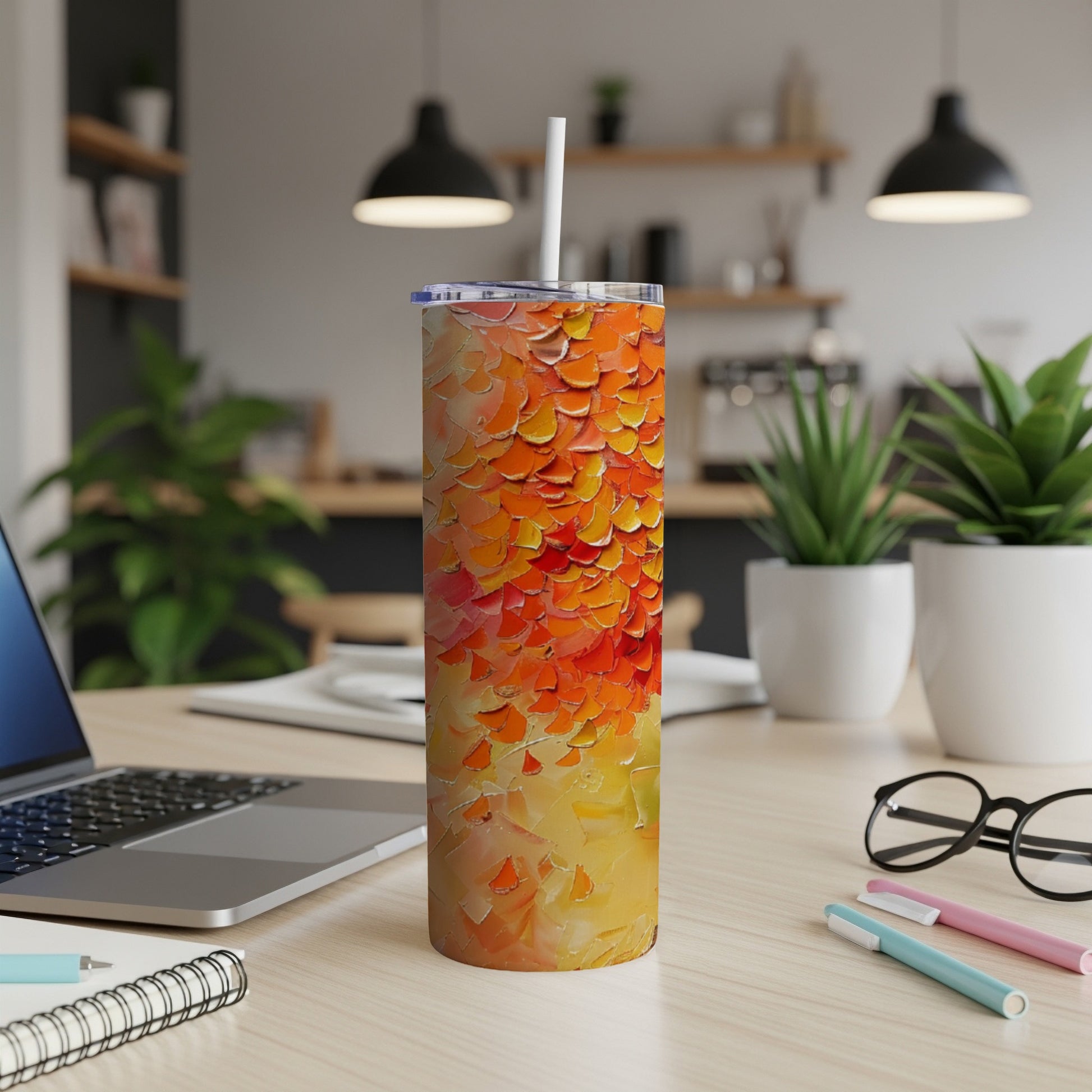Tall, insulated tumbler with a textured orange and yellow abstract design.