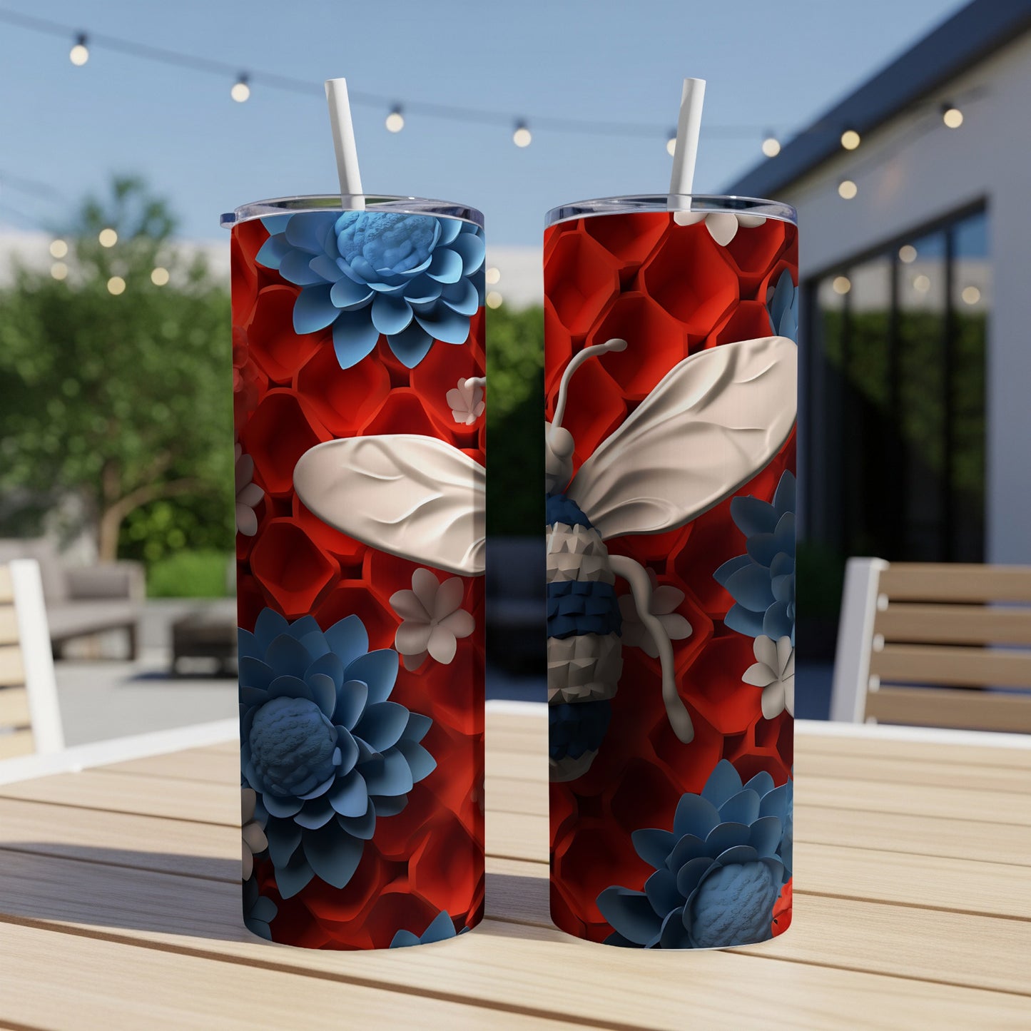 Two red and blue floral tumblers with a bumblebee design on a table.