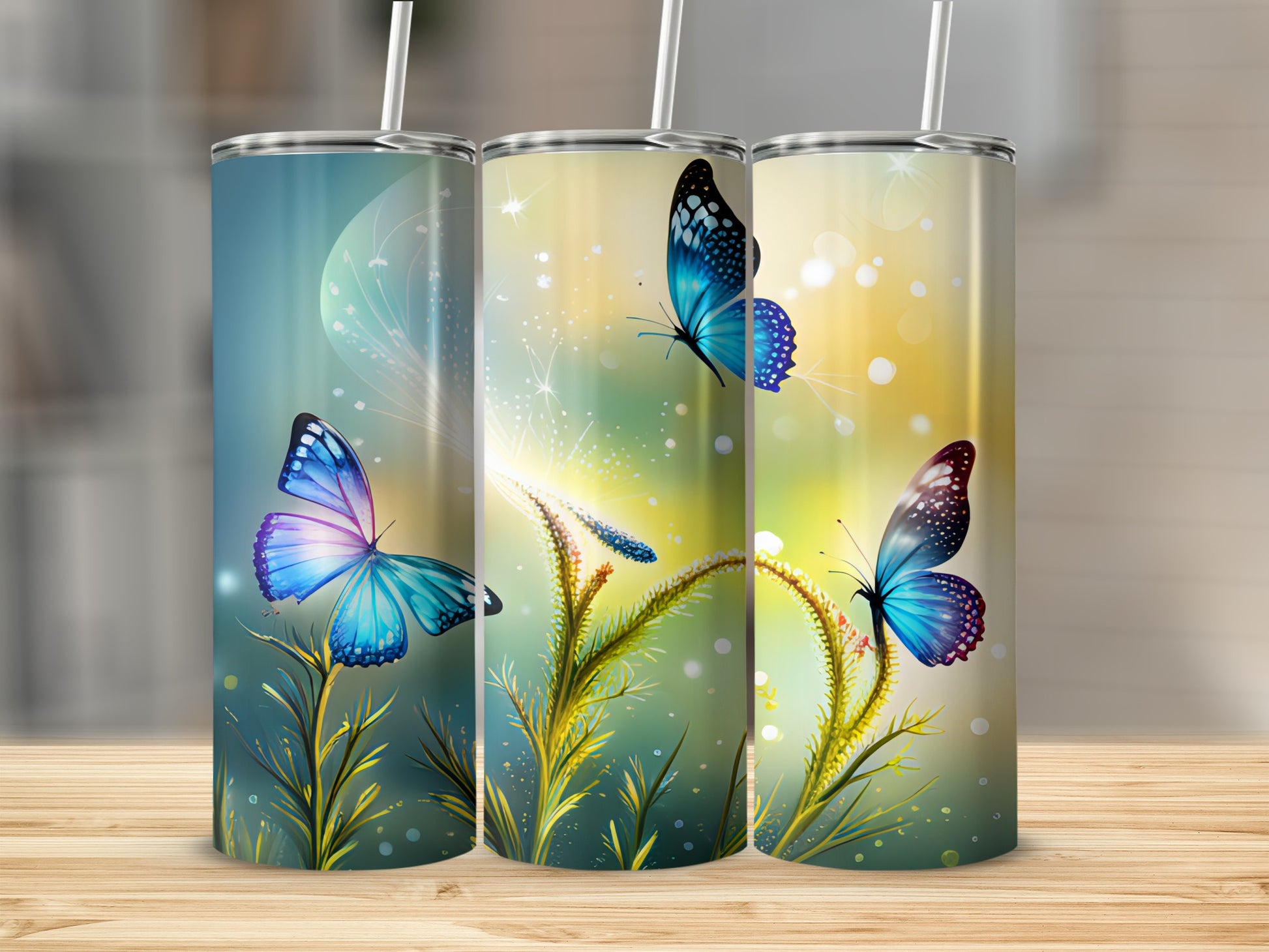 Three tumblers with blue butterflies and glowing floral accents.