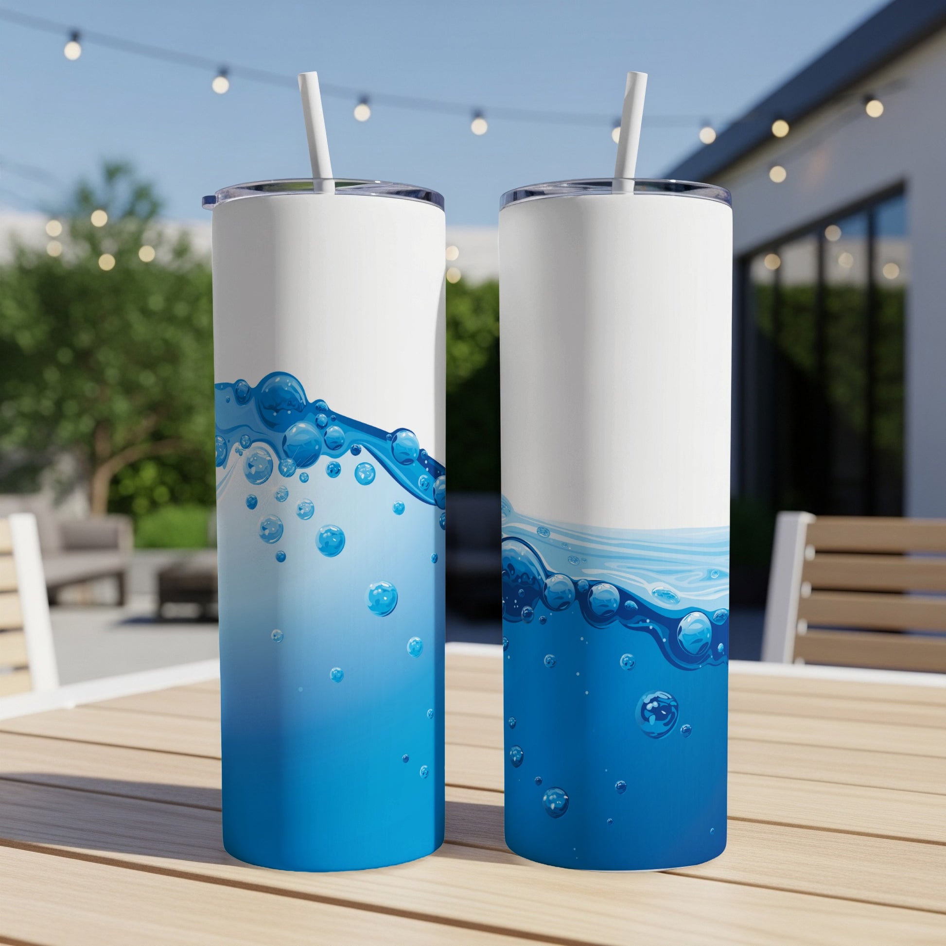 Two tall, slender tumblers with blue water and bubble designs.
