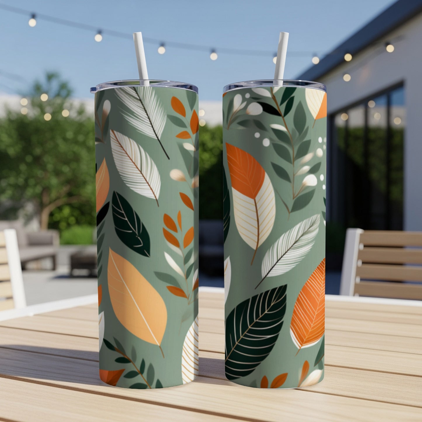 Two tumblers with green background and white, orange, and dark green leaf pattern.