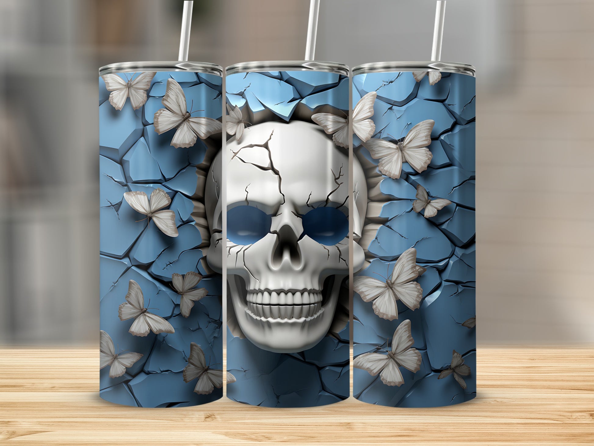 Three tumblers with a cracked blue background and butterflies, featuring a skull design.