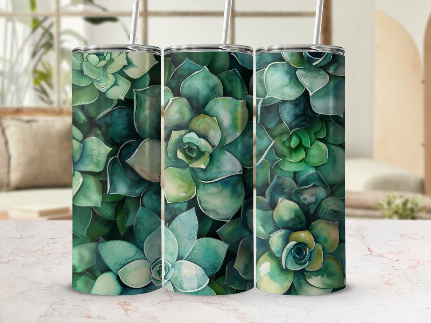 Three tumblers featuring a green succulent plant pattern on a marbled countertop.