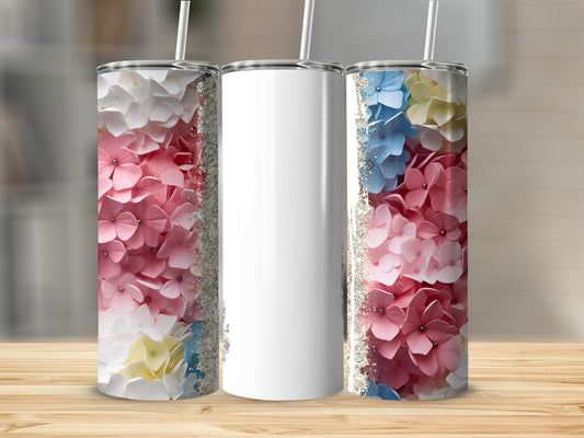 Three tumblers: two with pink and blue floral designs, one blank.