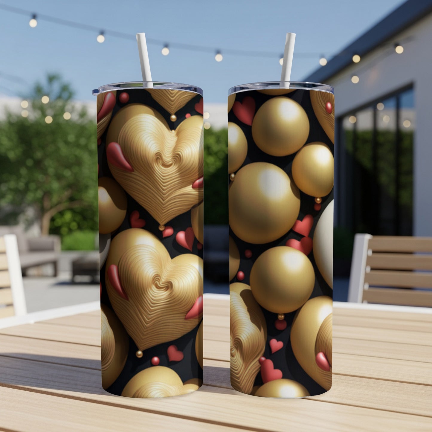 Two gold heart and sphere patterned tumblers on a wooden table.